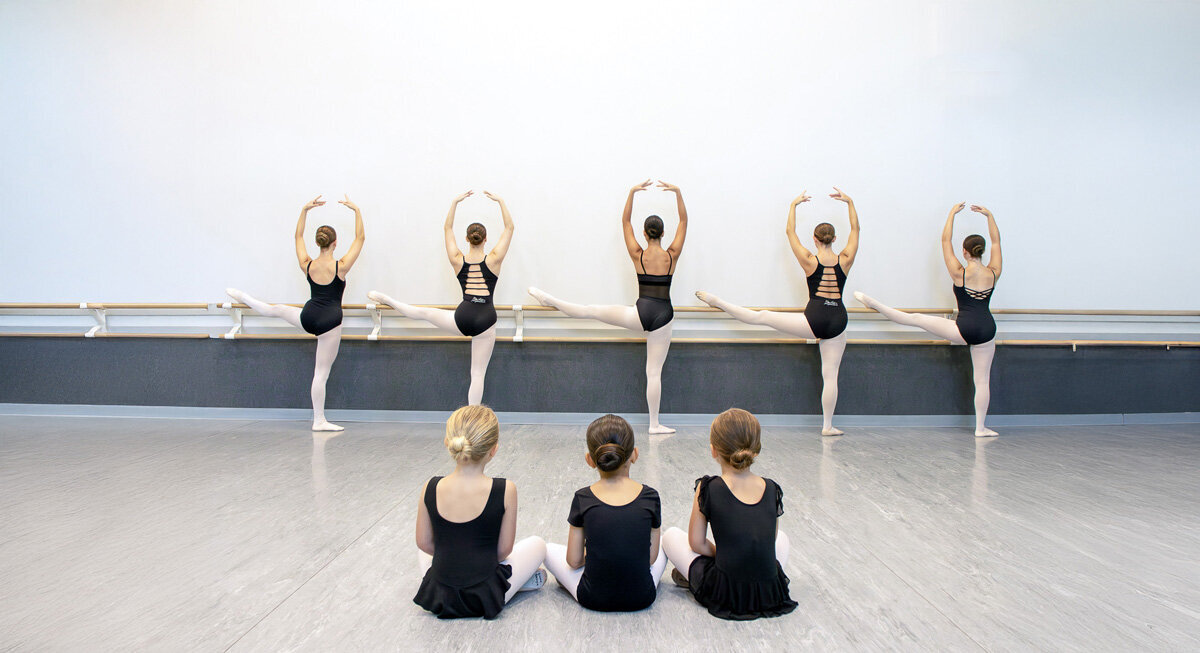 Dancers practicing splits in technique class at MSDA